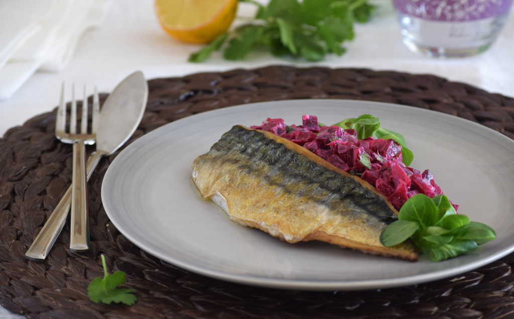 Imagen del plato de caballa con la ensalada cremosa sobre un tapete mimbre.