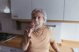 Abuela hidratándose con un baso de agua