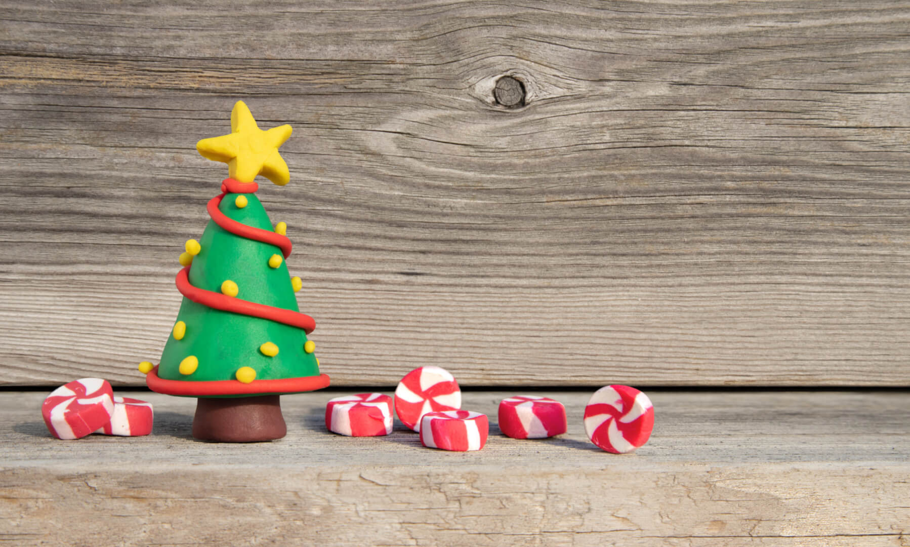 En la imagen se muestra un árbol de navidad hecho con arcilla polimérica con adornos como la estrella en la parte superior.