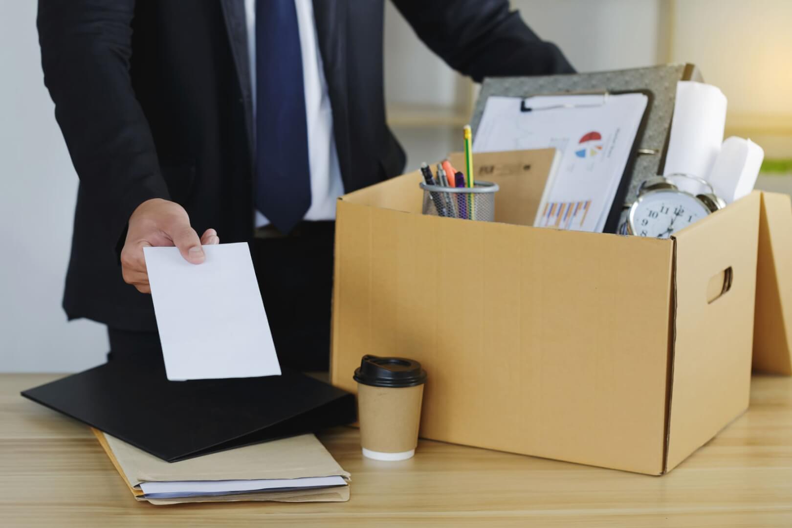 Una imagen de un empleado despedido mientras recoge sus cosas de la oficina en una caja.